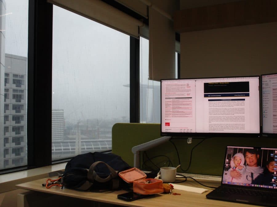 A rainy-day desk overlooking Marina Bay
