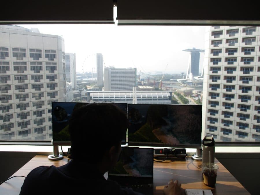 Matthias working at a desk overlooking Marina Bay