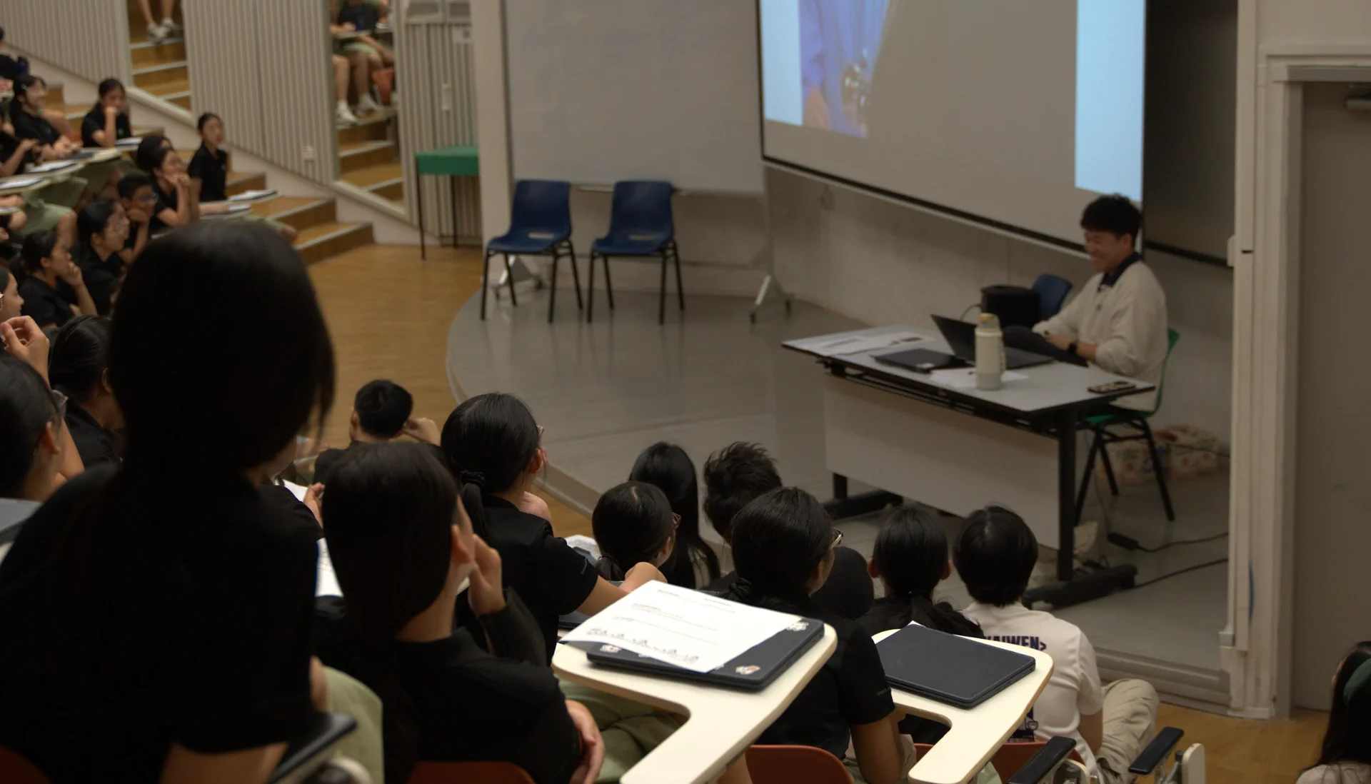Matthias Joseph at the front of a lecture theatre during a presentation at his old school.