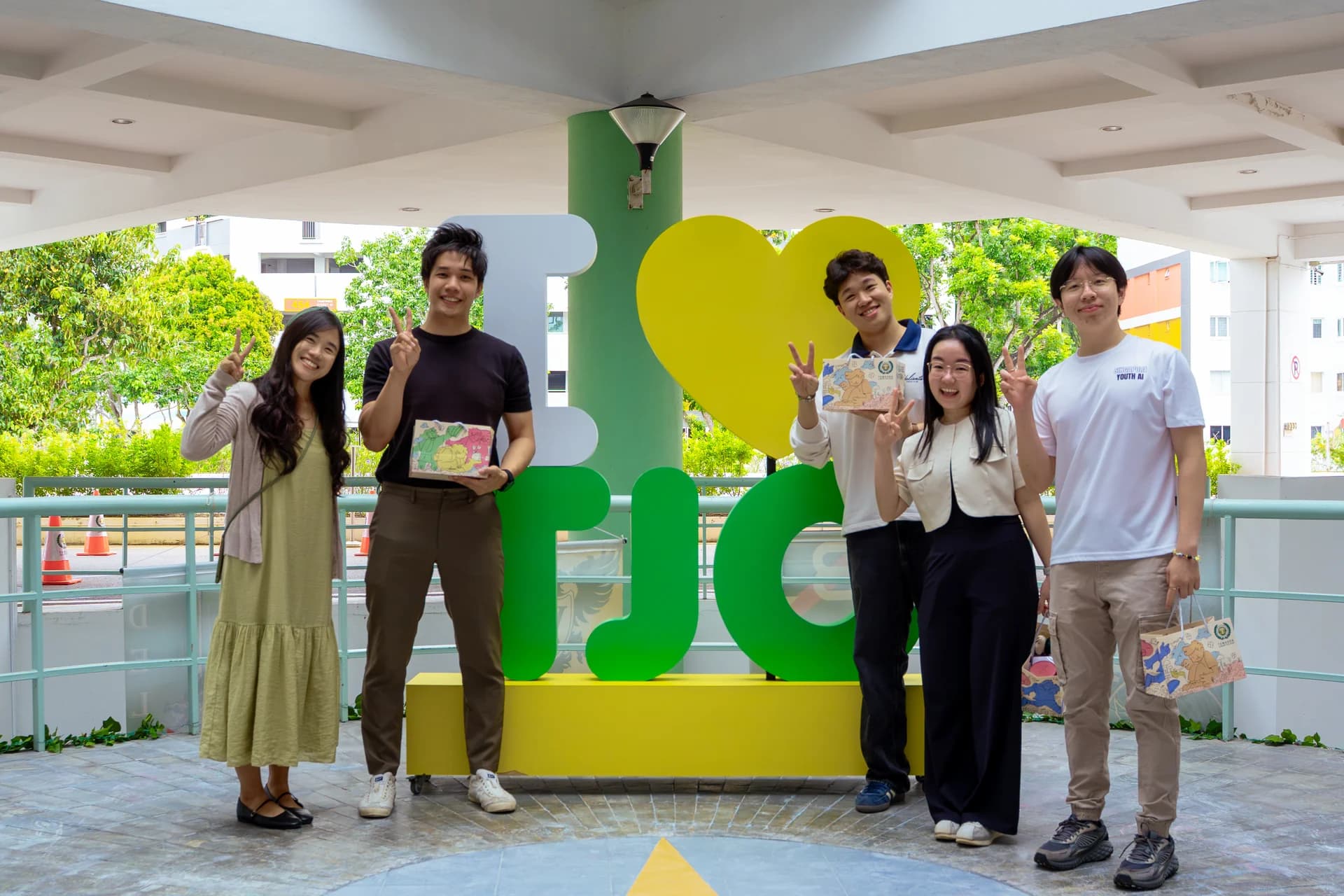 Matthias with a group at the I love TJC sign during his visit to speak at TJC