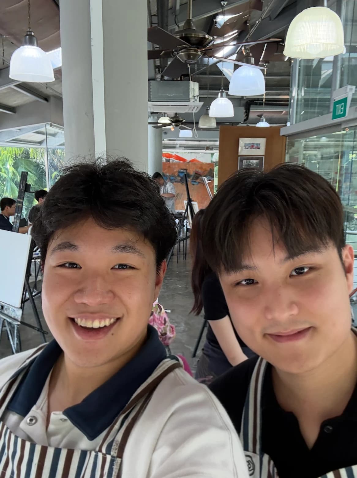 Matthias and Gerald wearing aprons at EDBI’s team painting session